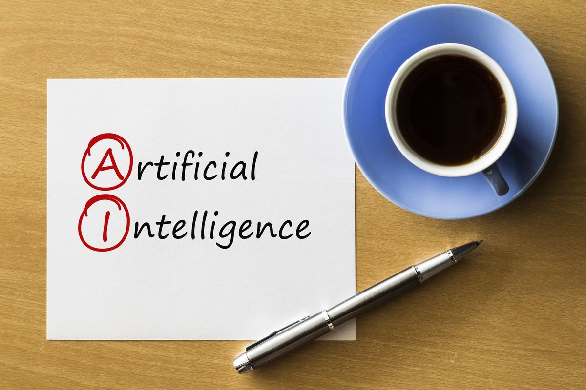 AI Artificial Intelligence - handwriting on notebook with cup of coffee and pen, acronym business concept